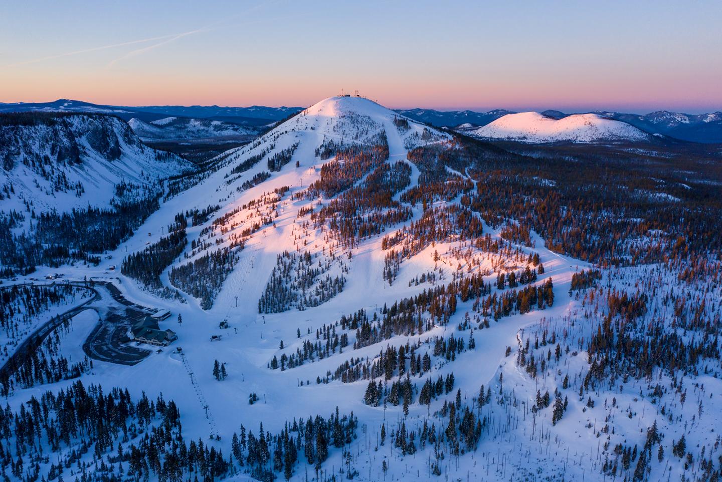 Hoodoo Ski Area in USA - a mountain covered in snow at sunset.