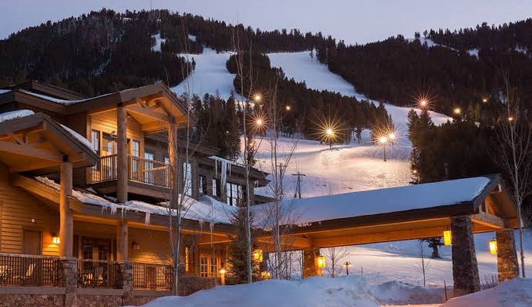 Overlooking the picturesque ski resort at Snow King Mountain Wyoming one can spot a ski lift that outlines the serene winter scenery. Enthusiasts enjoy winter sports while a lodge offers warmth and shelter.