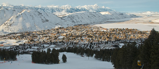 A vibrant winter scene at Snow King Mountain ski resort in Jackson Wyoming featuring snow-covered slopes a beautiful challet
