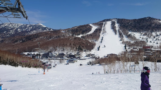 Ski resort at Shiga Kogen Nishitateyama in Nagano, Japan, featuring pristine slopes for winter sports, cozy chalet, amidst stunning winter scenery.