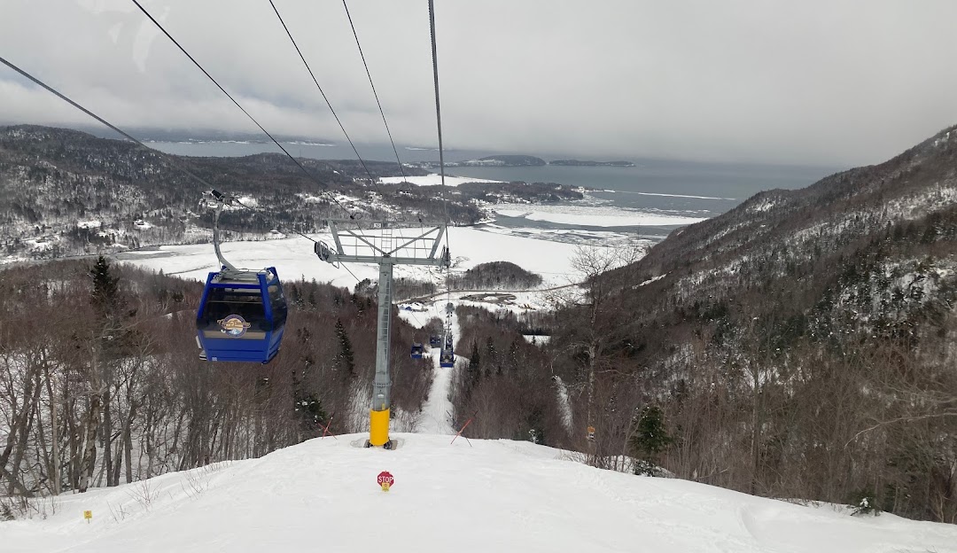 A lively winter sports scene at Ski Cape Smokey Ingonish Beach Nova Scotia featuring a ski lift skier
