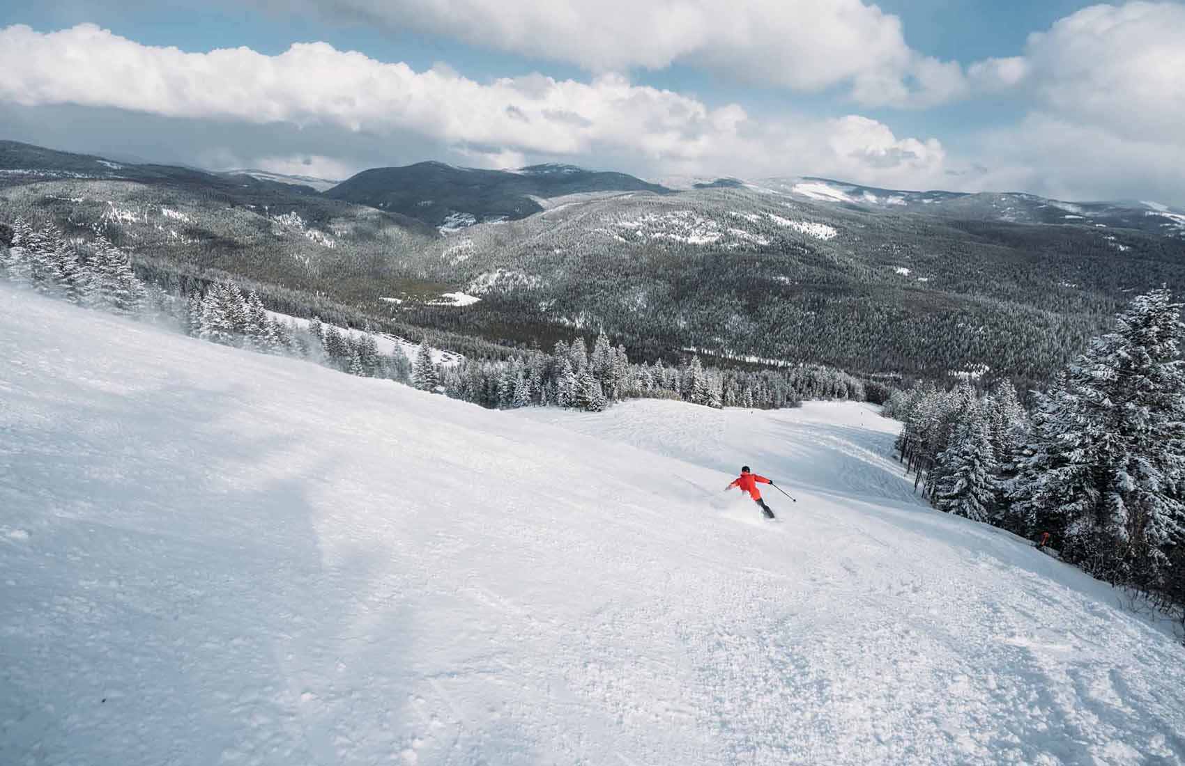 Turner Mountain in USA - a person riding a snowboard down a snowy slope.