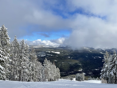 An action-packed winter sports scene at Turner Mountain ski resort in Libby Montana featuring a stunning snowy mountain and pristine winter scenery.