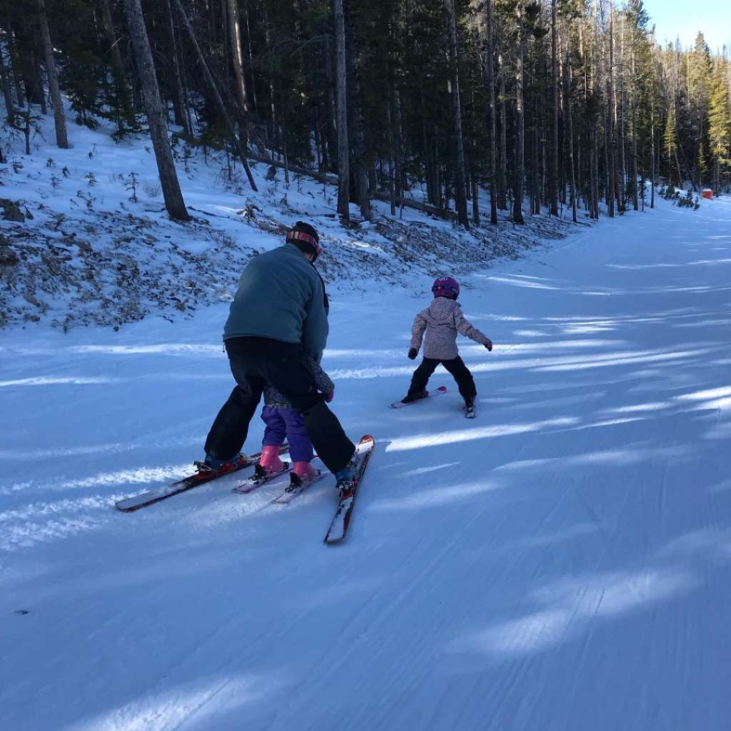 Snowy Range in USA - two people skiing down a snow covered hill.