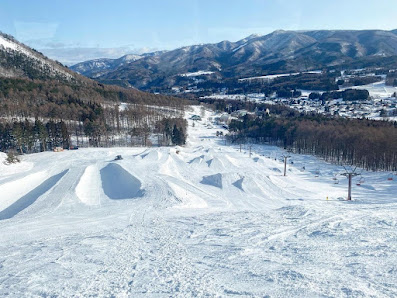 Ski resort at X-JAM Takaifuji in Nagano, Japan showcasing stunning winter scenery, snow-covered slopes, with visible ski lift for winter sports.