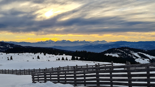 Winter sports scene with snow-covered mountain backdrop at Klippitztörl, Lower Carinthia, Austria. A charming chalet nestles amidst the stunning winter landscape.