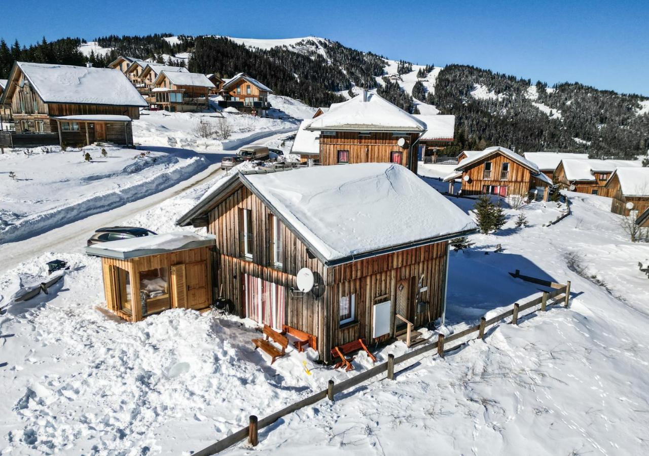 Klippitztörl in Austria - a house in the snow with mountains in the background.