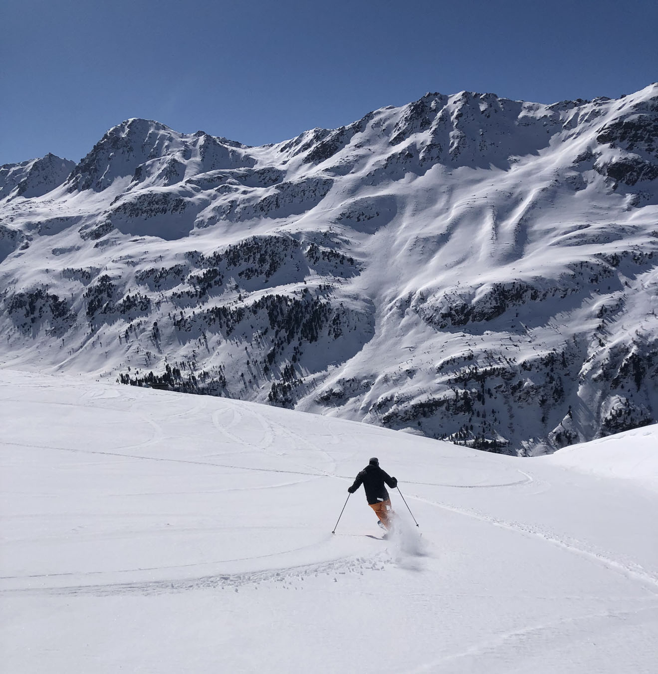 Bivio in Switzerland - a person skiing down a snow covered mountain.