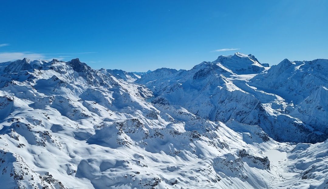 4 Vallees | Verbier in Switzerland - a view from the top of a snowy mountain.