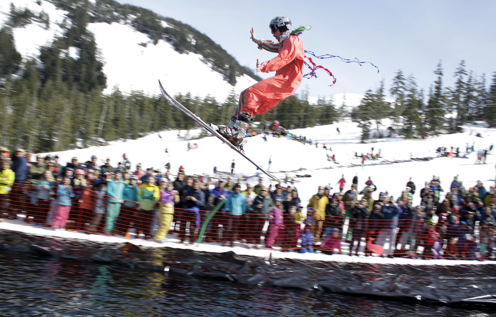 Ski Land Mt Aurora in USA - a man flying through the air while riding a snowboard.