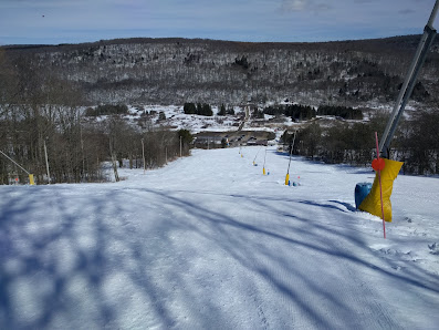A winter sports scene at Labrador Mountain a ski resort in Truxton New York USA. Skiers glide down the slopes
