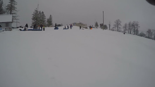 A lively winter scene at Blue Knob ski resort in Pennsylvania USA features a bustling ski resort with active skiers a winter sports center