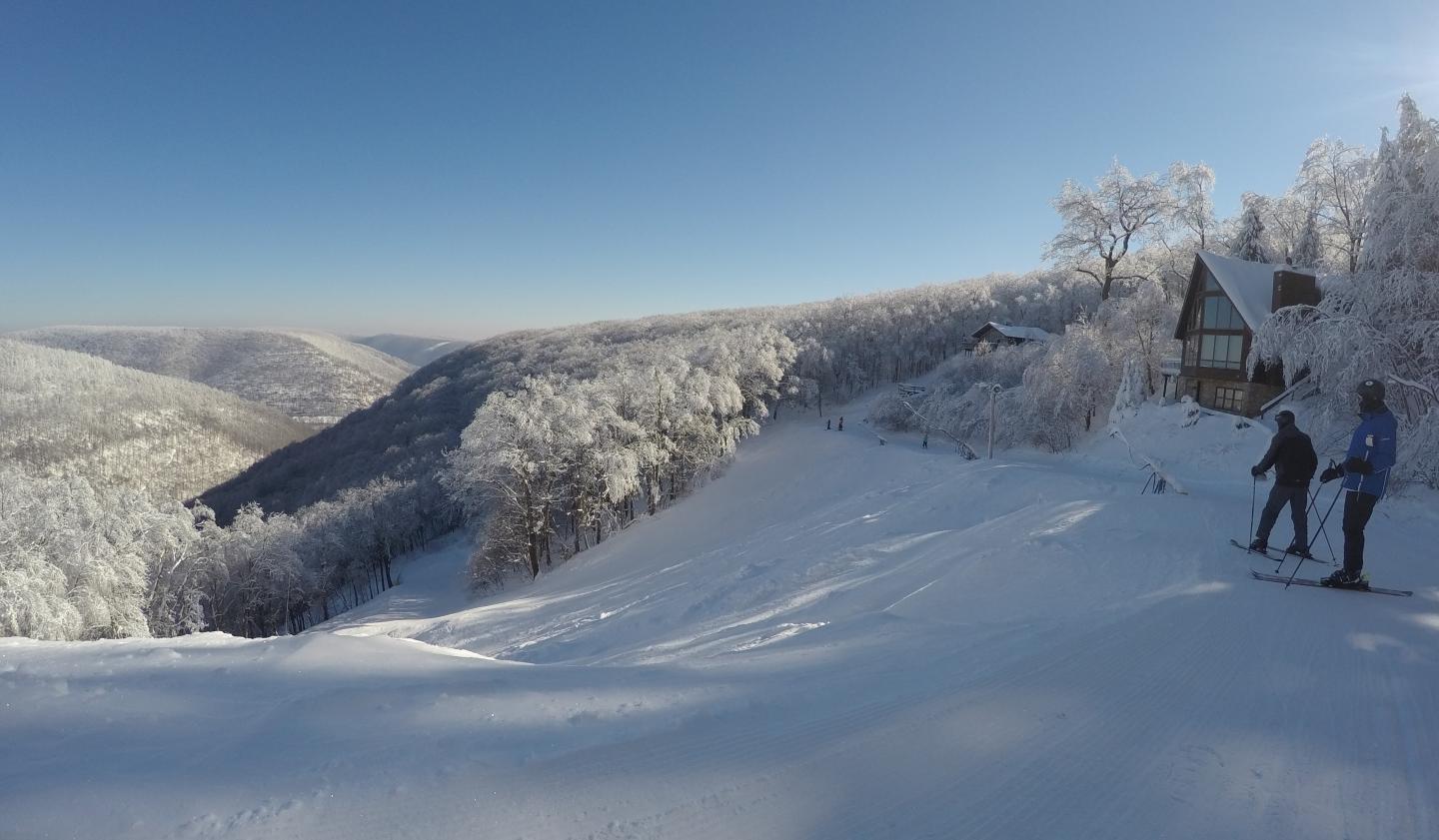 Blue Knob in USA - a person skiing down a snowy mountain.