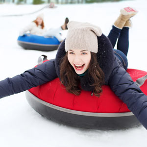 Blue Knob in USA - a woman sled down a hill in the snow.