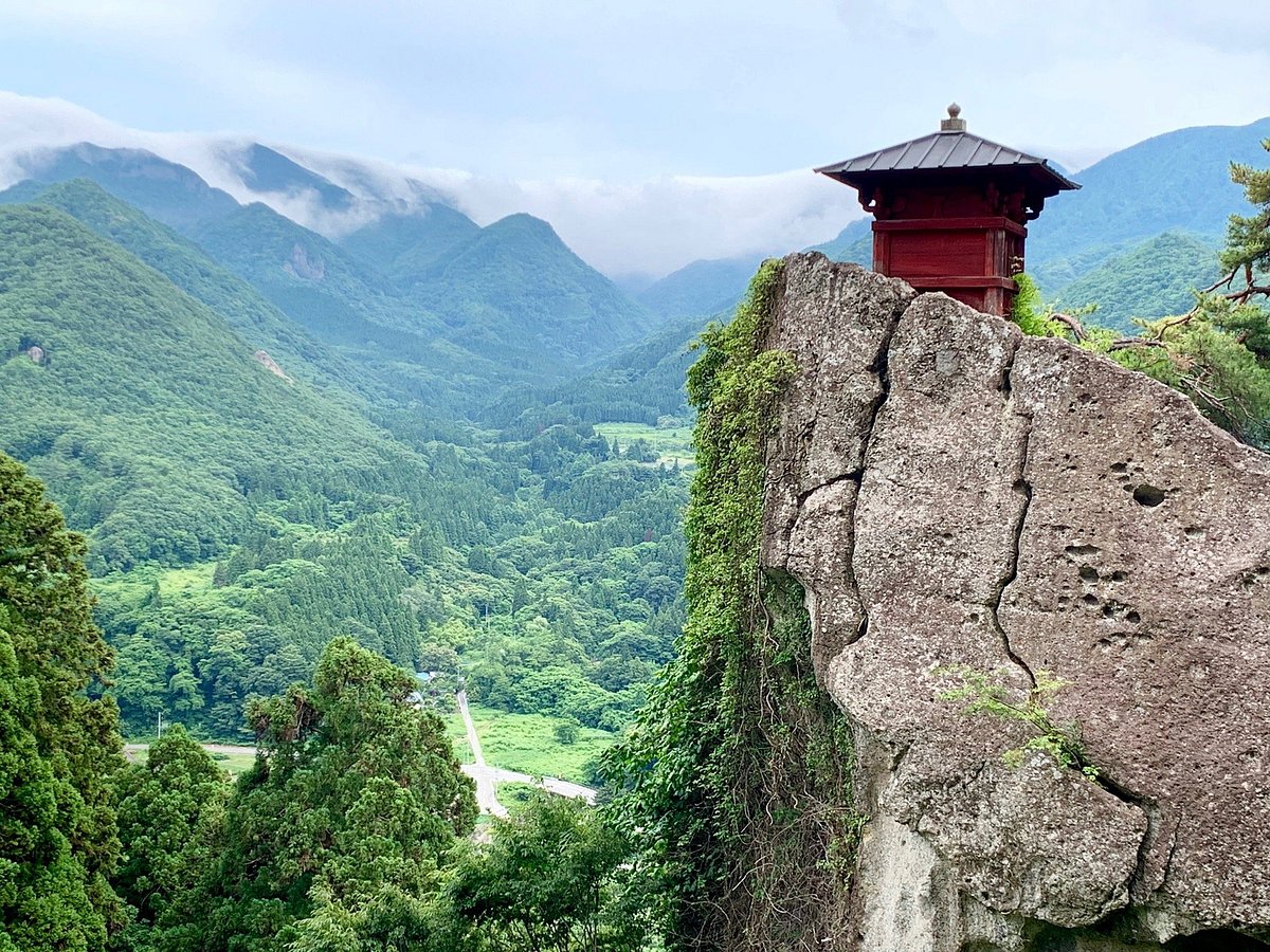 Grand Sunpia Inawashiro Snow Paradise in Japan - a red pagoda sits on top of a rock.