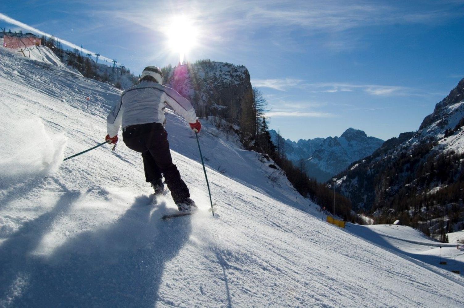 Sappada in Italy - a person is skiing down a snowy slope.