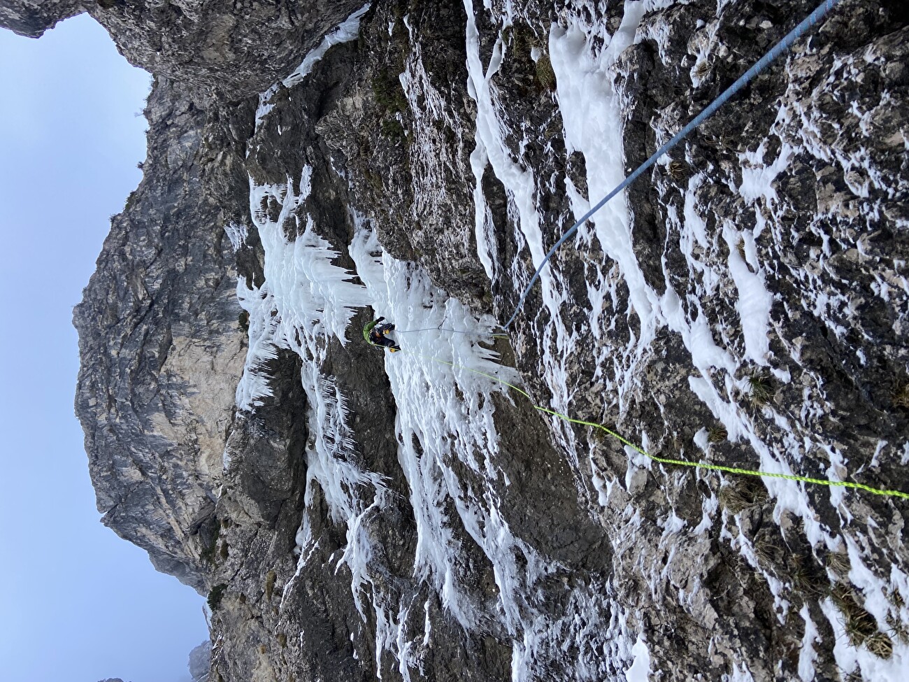 Sappada in Italy - a person climbing up a snowy mountain.