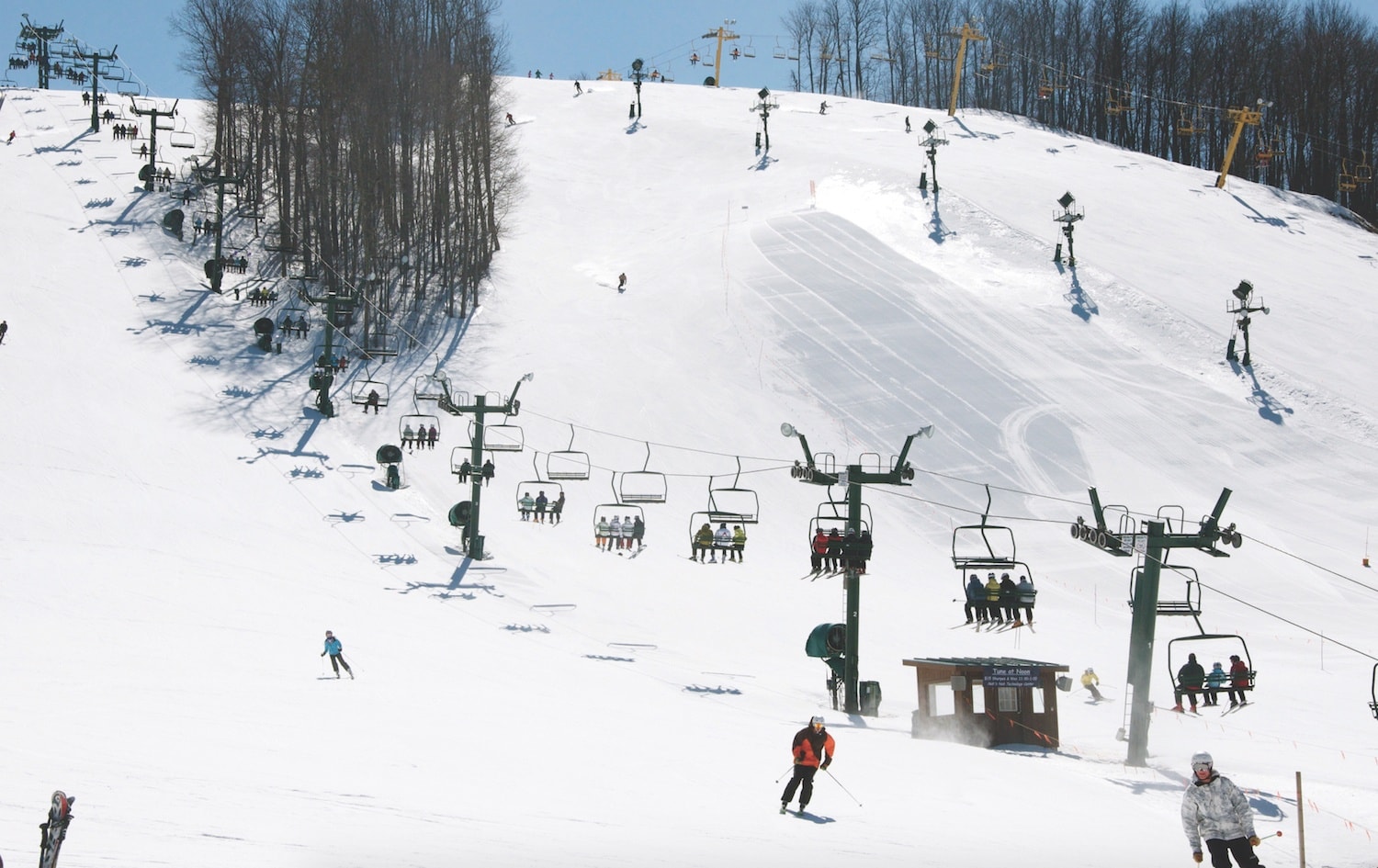 Nub's Nob Ski Area in USA - a group of people skiing down a snowy hill.