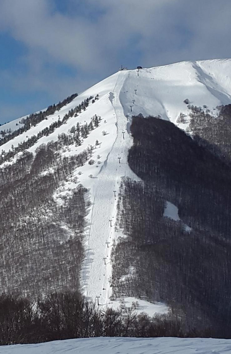 Pescasseroli in Italy - a person on a snowboard on a snowy slope.