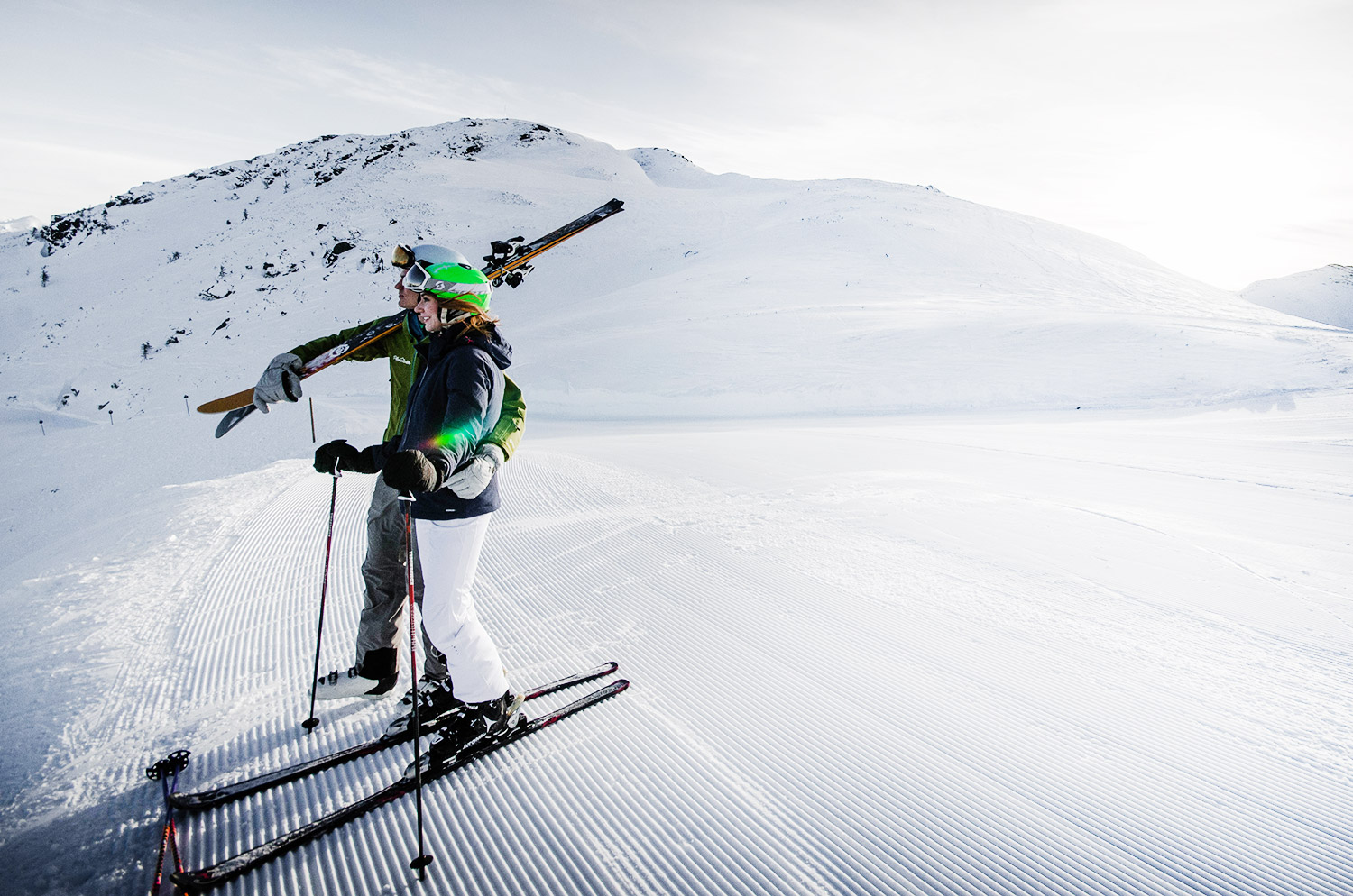 A skier enjoying a day on the slopes at Planneralm in Schladming-Dachstein, Styria, Austria with a backdrop of a vibrant winter sports scene.