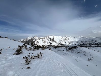 Snowy scene in Planneralm Austria capturing the wintery landscape of Schladming-Dachstein Liezen. Features include a bustling winter sports scene picturesque chalet snow-covered mountains.