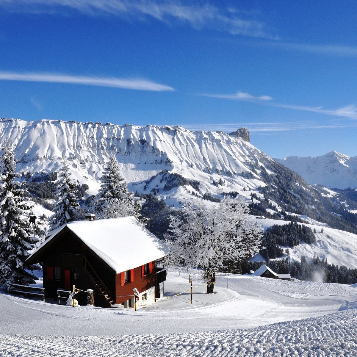 Sportbahnen Marbachegg in Switzerland - a red cabin sits on a snow covered mountain.