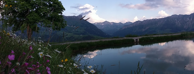 View of Sportbahnen Marbachegg in Lucerne Central Switzerland showcasing the vast mountain terrain the tranquil lake and a rustic challet
