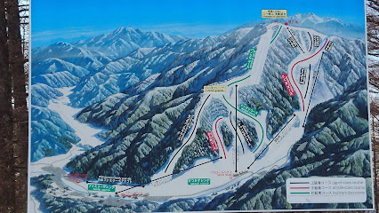 View of the Yabuhara Kogen ski resort in Nagano, Japan, featuring snow-covered slopes and a ski lift, under a clear winter sky.