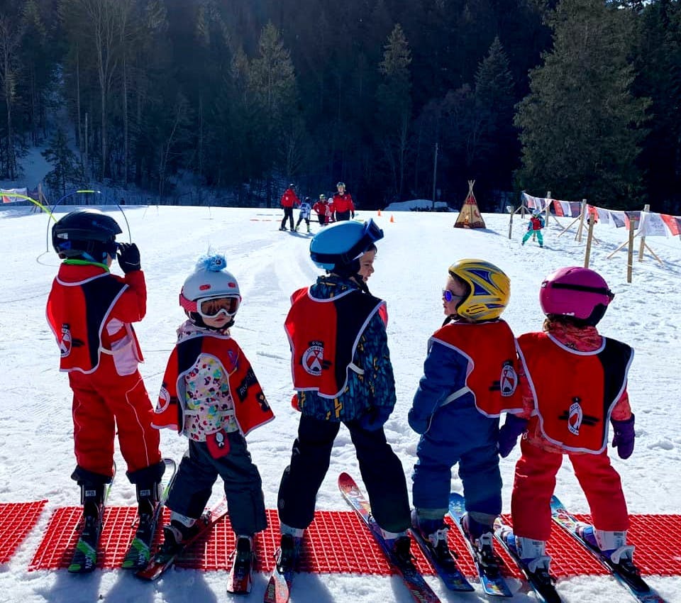Les Mosses - La Lécherette in Switzerland - a group of children on ski equipment in the snow.