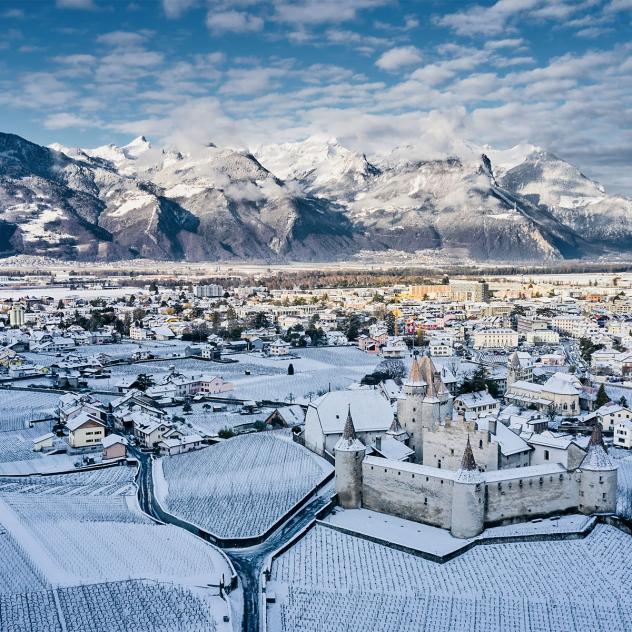 Winter panorama in Les Mosses - La Lécherette, Switzerland featuring a stunning icy landscape, a charming chalet, and a scenic snowy mountain.