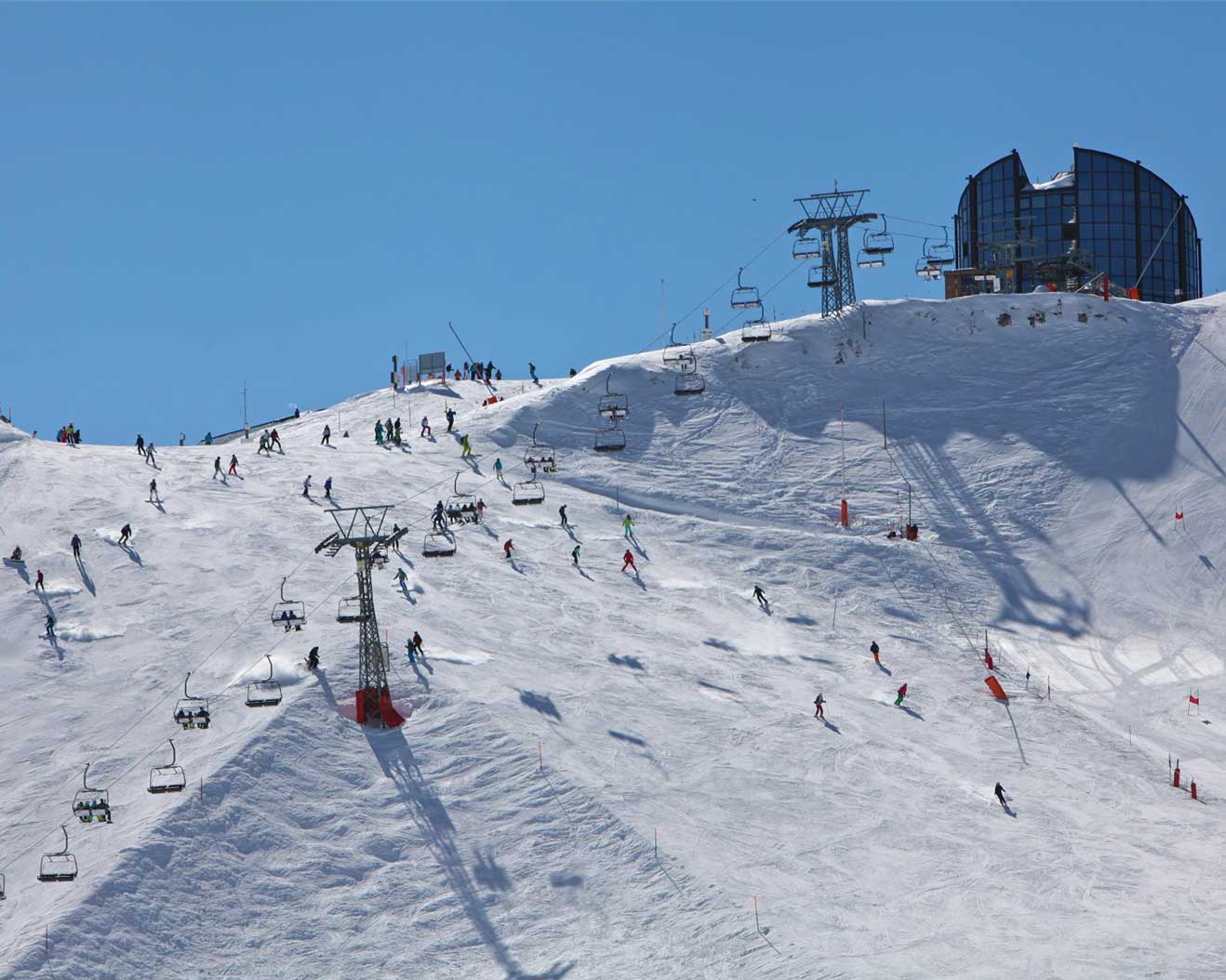 Les Mosses - La Lécherette in Switzerland - a group of people skiing down a snowy hill.