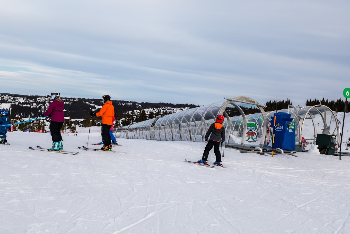 Hafjell in Norway - a group of people skiing down a snowy slope.
