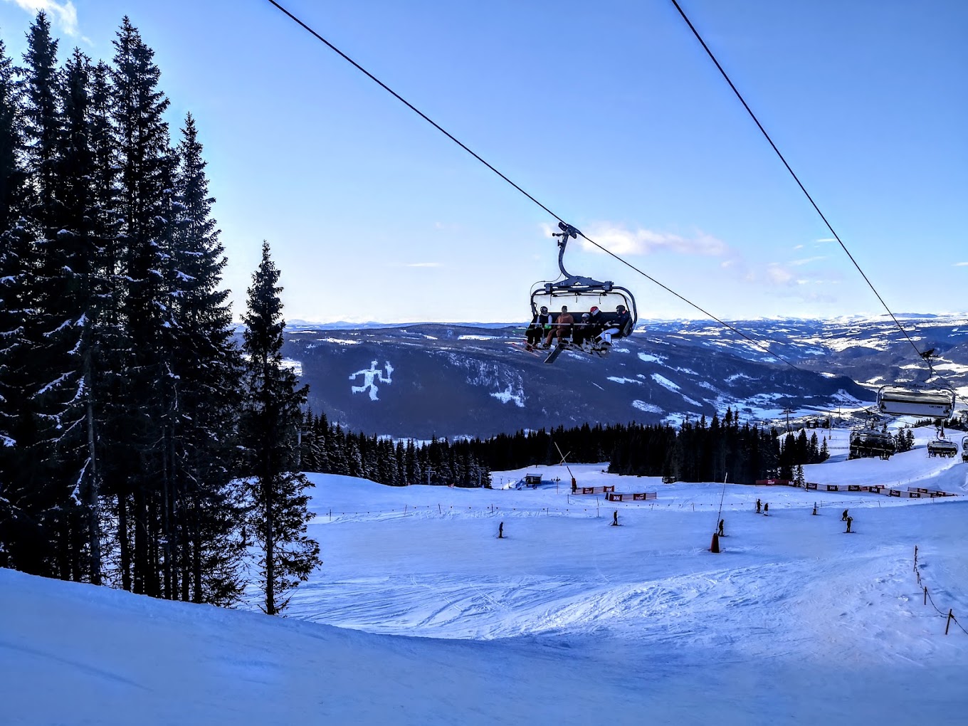 Hafjell in Norway - a ski lift going up a snowy slope.