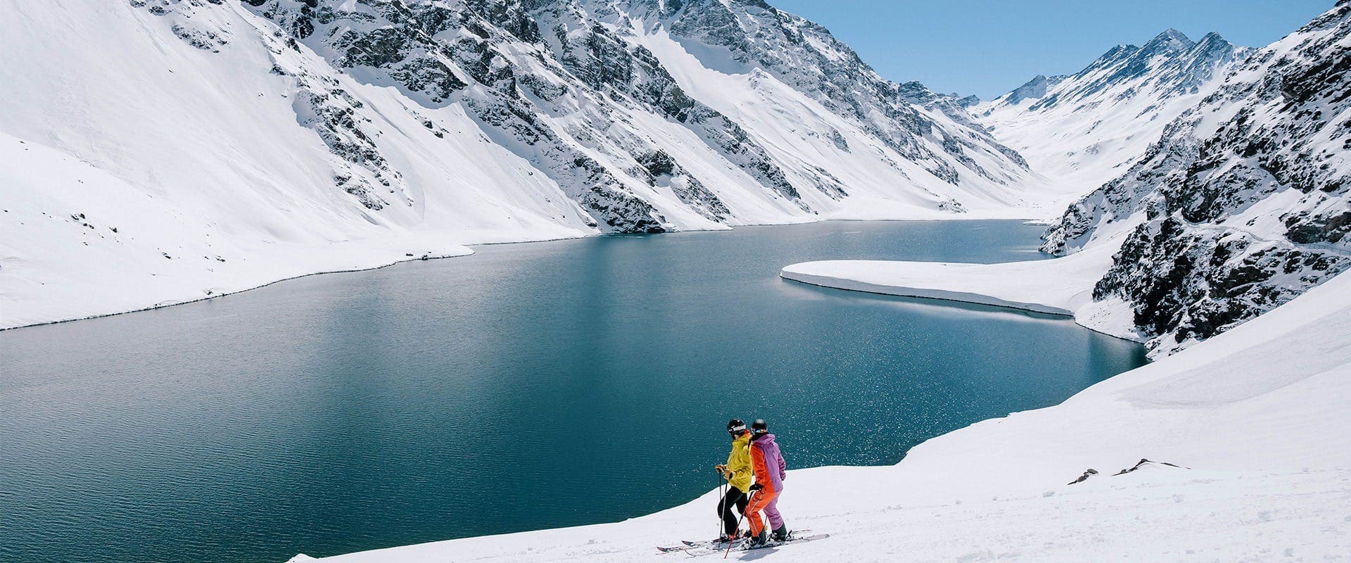 Portillo in Chile - a person standing on top of a snow covered mountain.