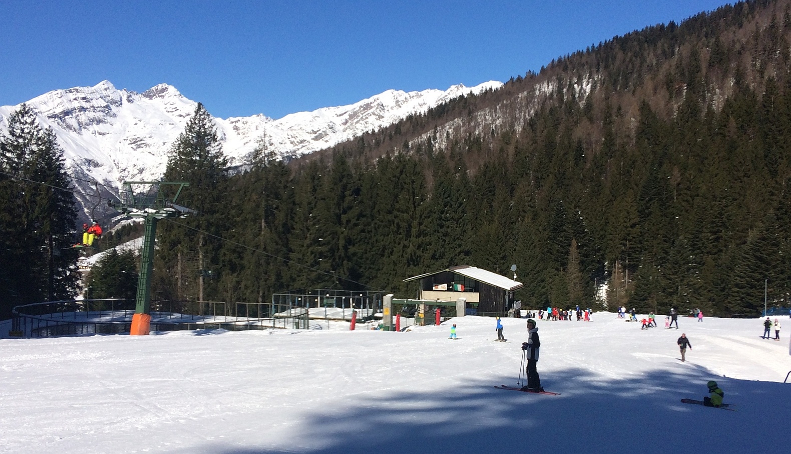Spiazzi di Gromo in Italy - a group of people riding ski boards on a snowy slope.
