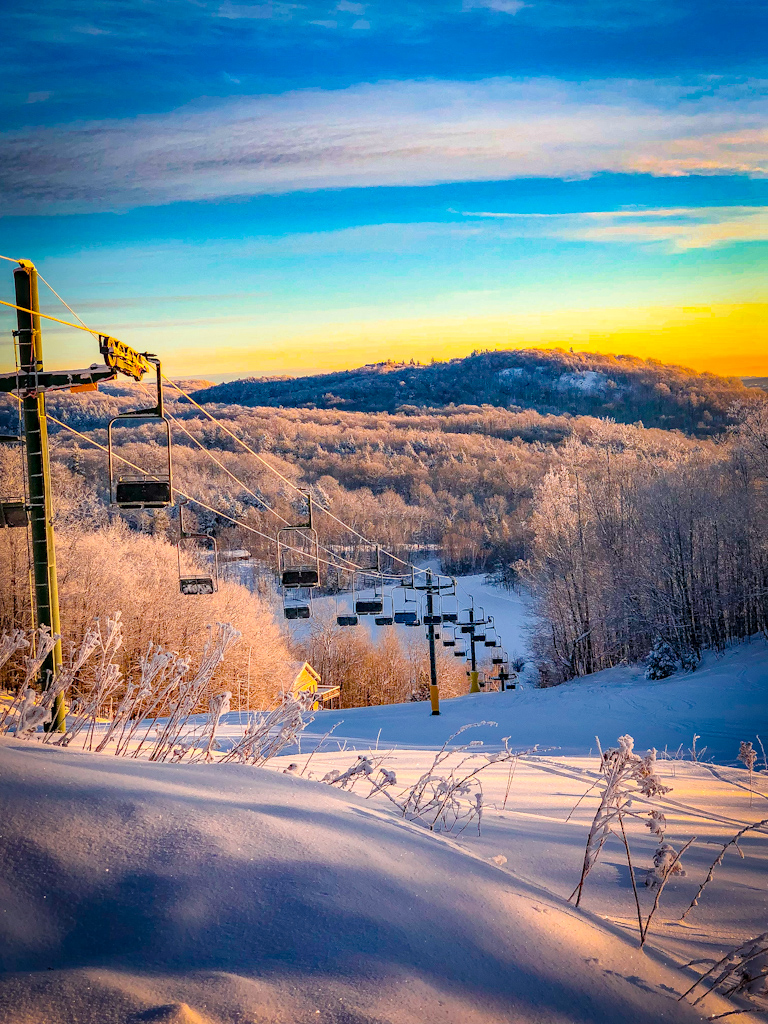 Whitecap Mountains in USA - a ski lift going up the mountain at sunset.
