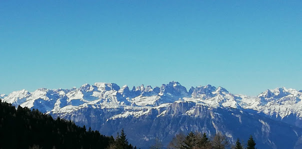 A challet surrounded by stunning Alpine scenery in Panarotta 2002, Trentino. Snow covers the landscape, indicating winter sports activities.