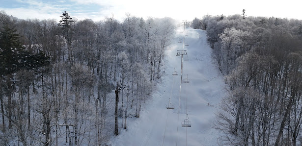 Winter scene at the Middlebury Snowbowl in Vermont, USA showing a ski lift amidst stunning snow covered scenery at the ski resort.