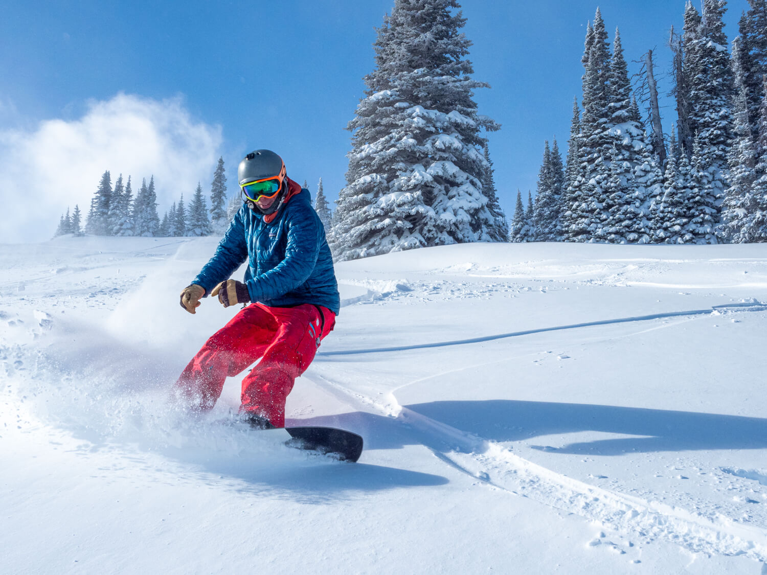 Pomerelle in USA - a man riding a snowboard down a snow covered slope.