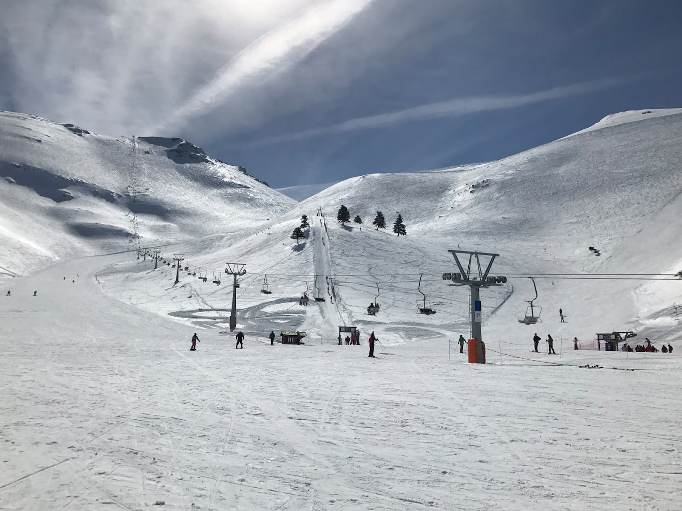 Winter scene at the Ski Center in Chelmos, Kalavrita, Western Greece featuring a ski resort with a chalet, a ski lift, and snow-covered slopes for winter sports.