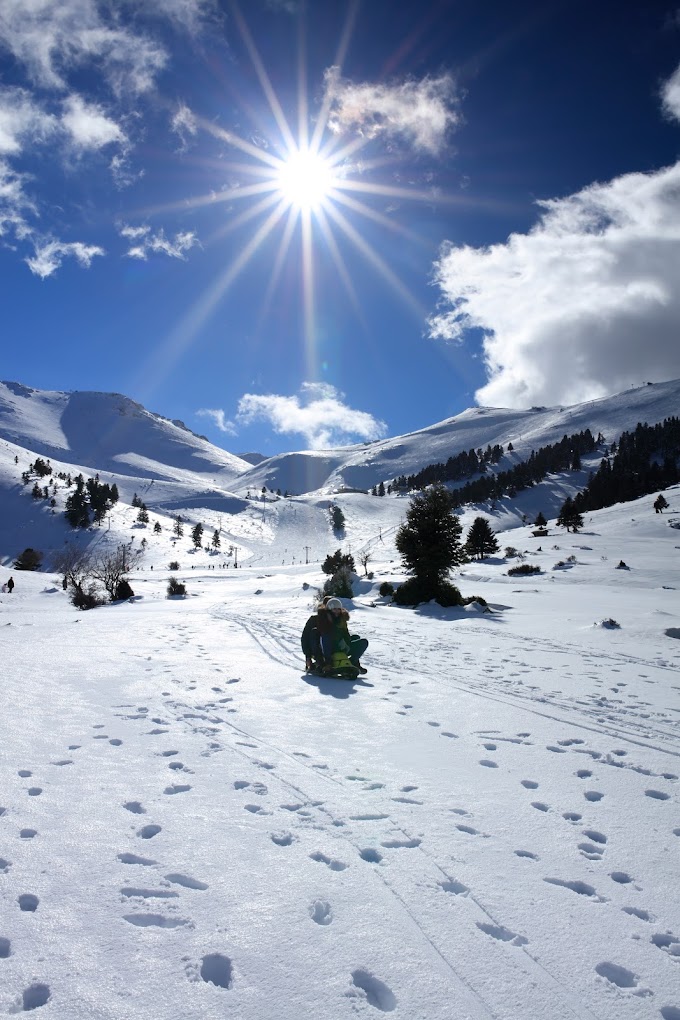 Winter scene at the Ski Center in Chelmos, Kalavrita, Western Greece, showcasing stunning winter scenery with a chalet and ski resort facilities amidst the snow-covered landscape.