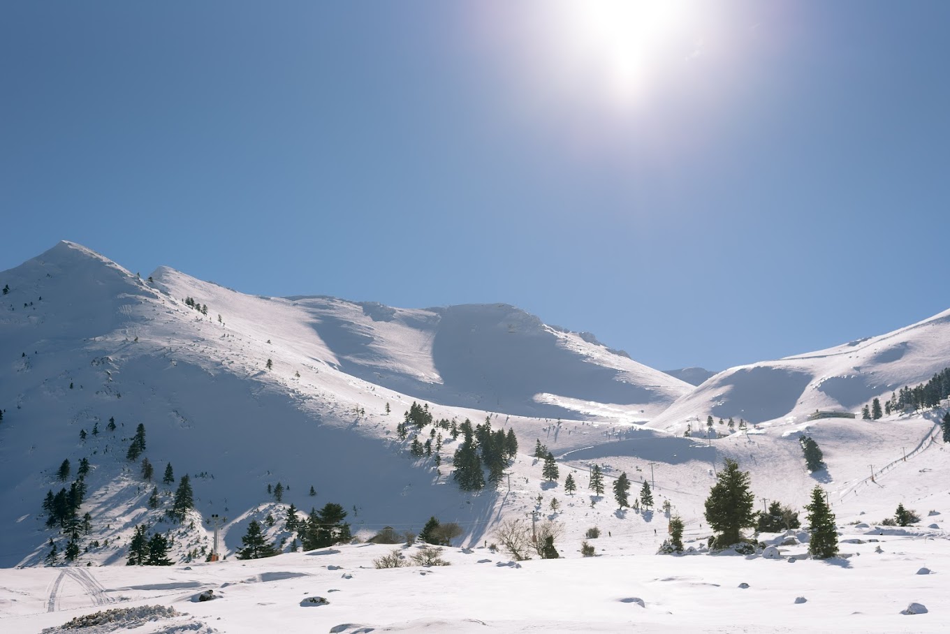 View of a winter sports scene at Ski Center in Chelmos Kalavrita Western Greece with snowy mountains in the backdrop amidst stunning winter scenery.