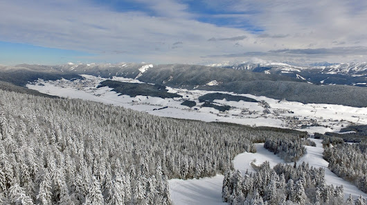 A picturesque view of Autrans-Méaudre ski resort in France showcasing snow-covered slopes and a ski lift capturing the essence of a winter sports scene.