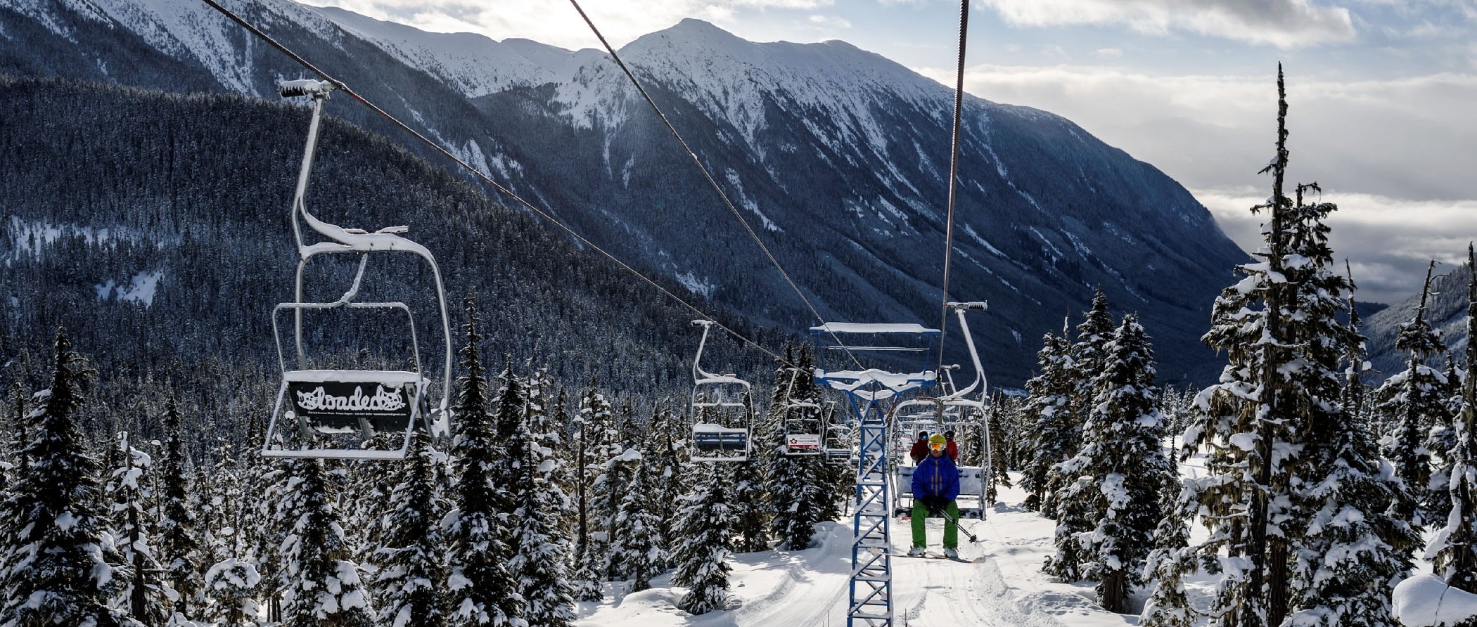 Tabor Mountain in Canada - a person riding a ski lift in the snow.