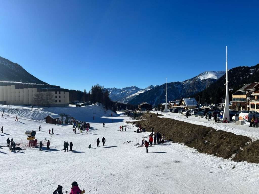 Ascou Pailhères in France - a group of people skiing down a snow covered slope.
