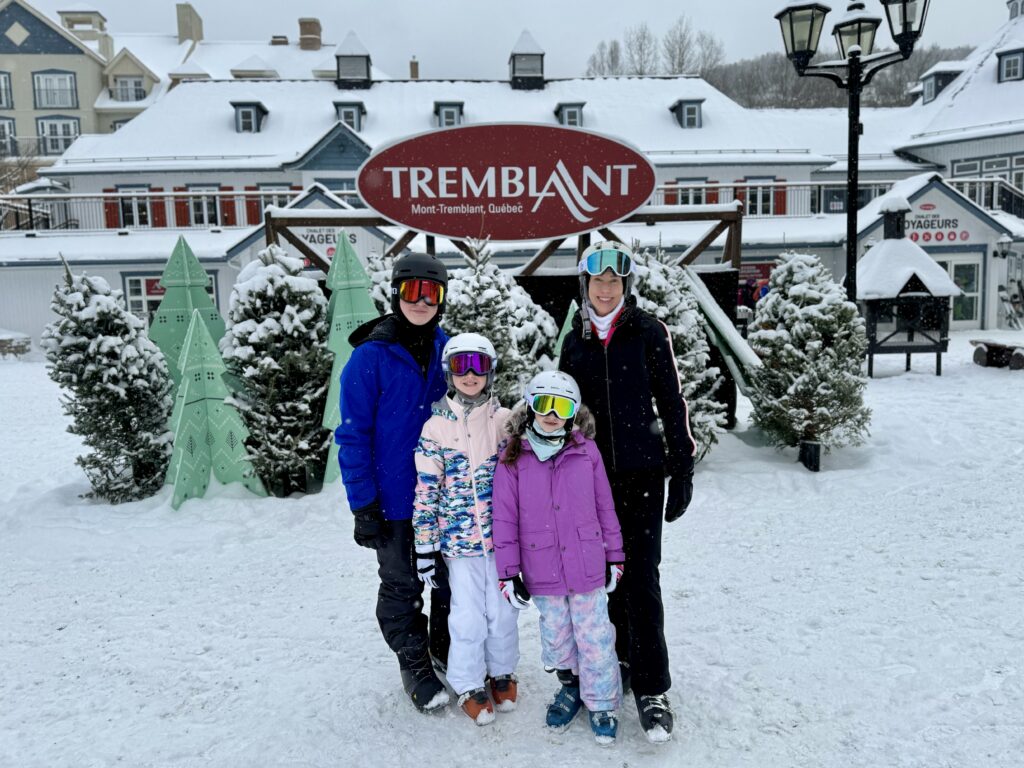 Mont-Tremblant in Canada - three people standing in front of a restaurant in the snow.