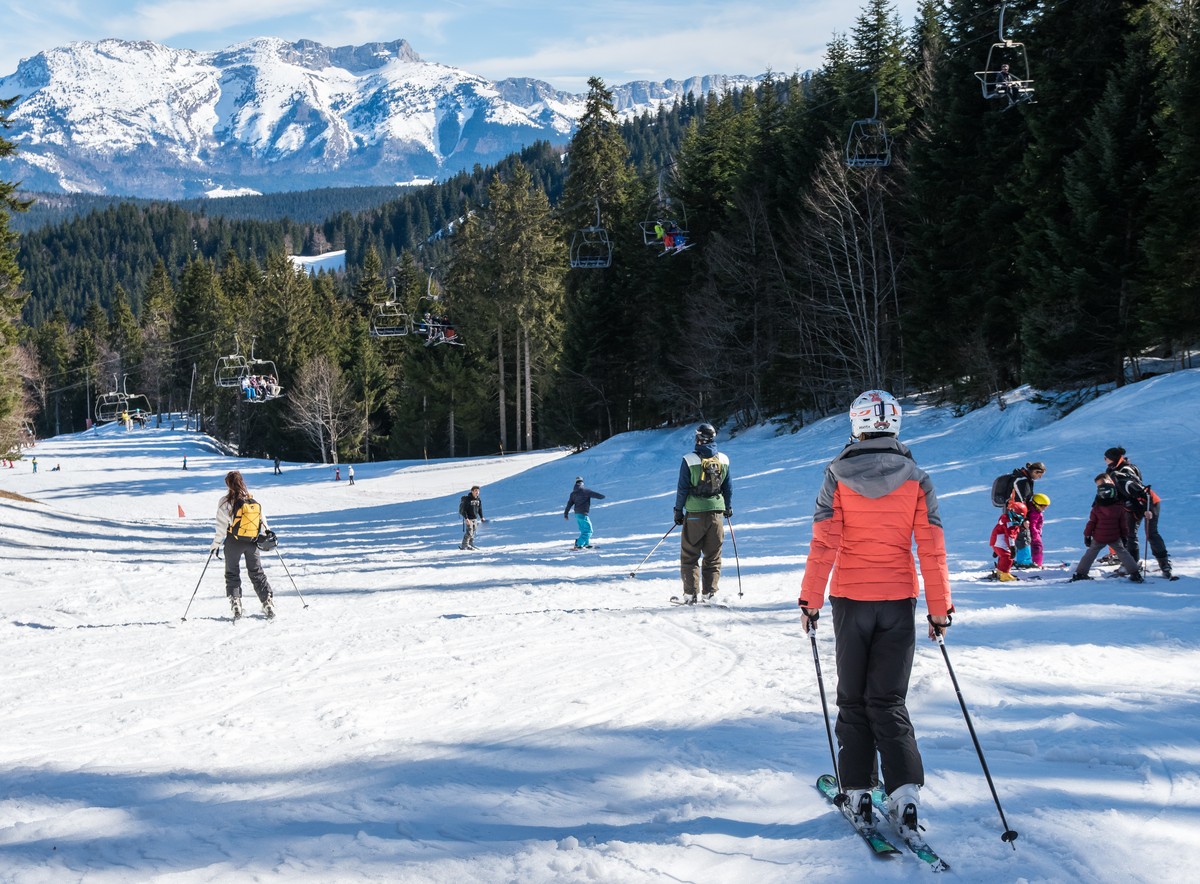 Autrans Snow in France - a group of people skiing down a snowy slope.