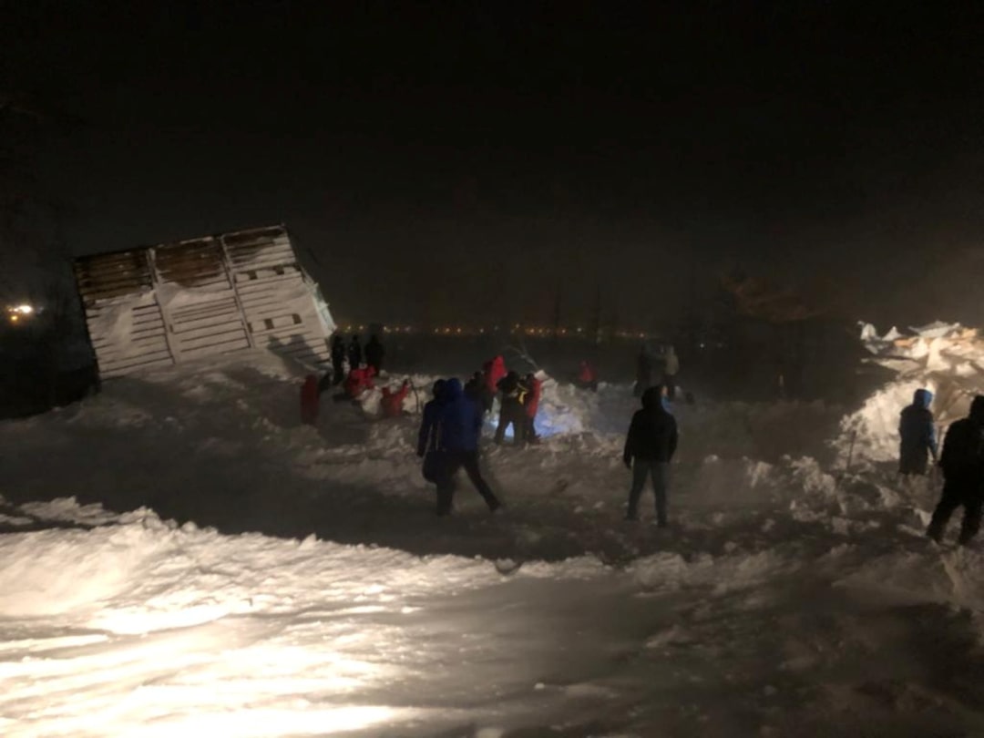 Gora Otdelnaya in Russia - several people are walking through the snow covered road.
