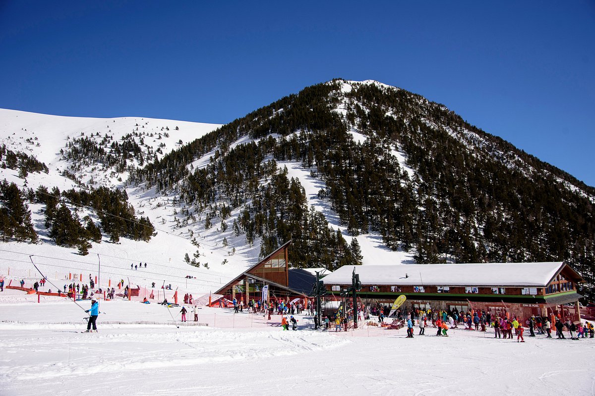 Vallter 2000 in Spain - a group of people skiing down a snow covered mountain.