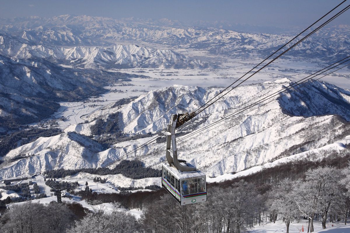 Muikamachi Hakkaisan in Japan - a ski lift going up a snowy mountain.